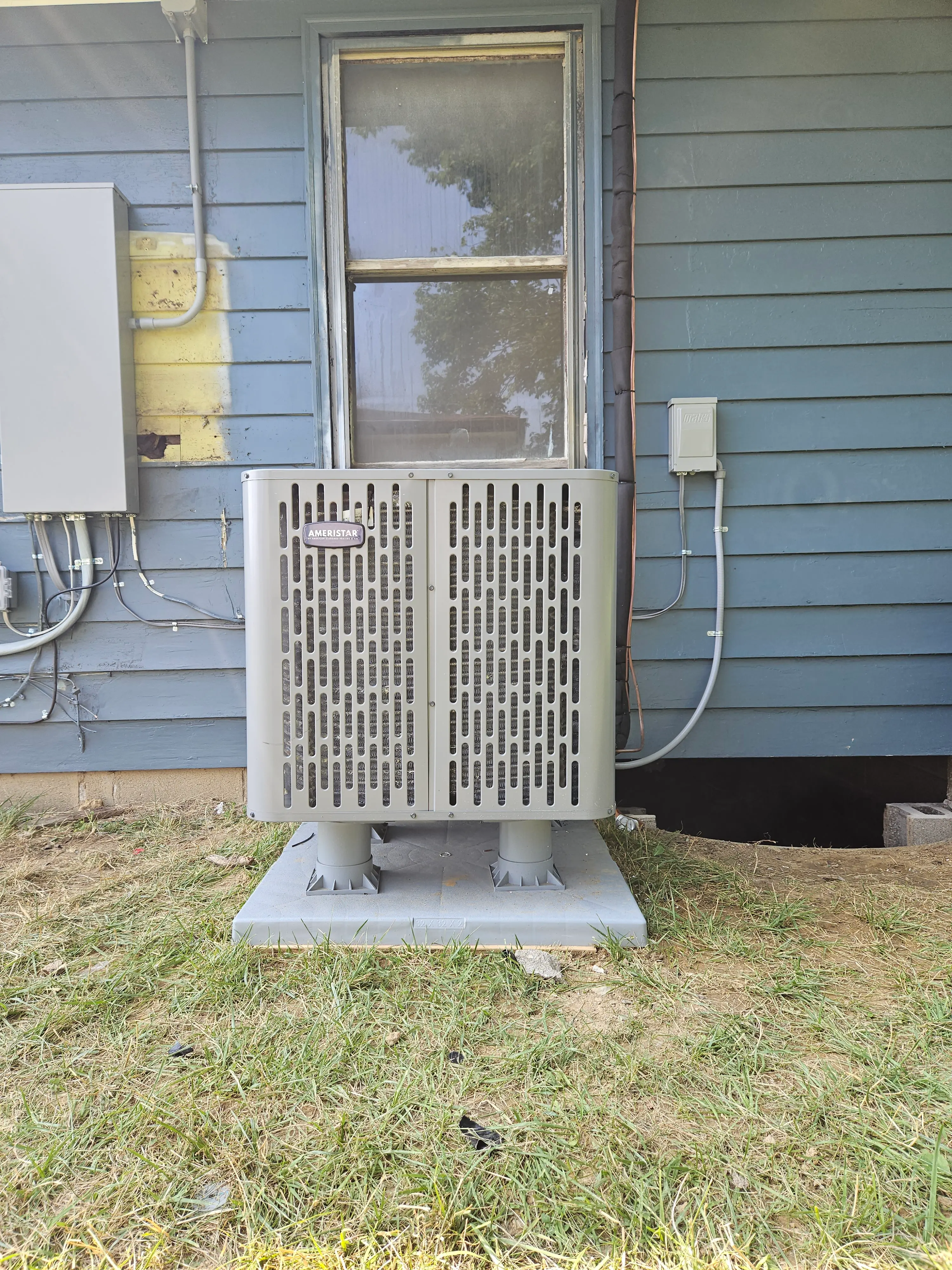 HVAC technician reviewing repair options with a homeowner next to an outdoor AC unit